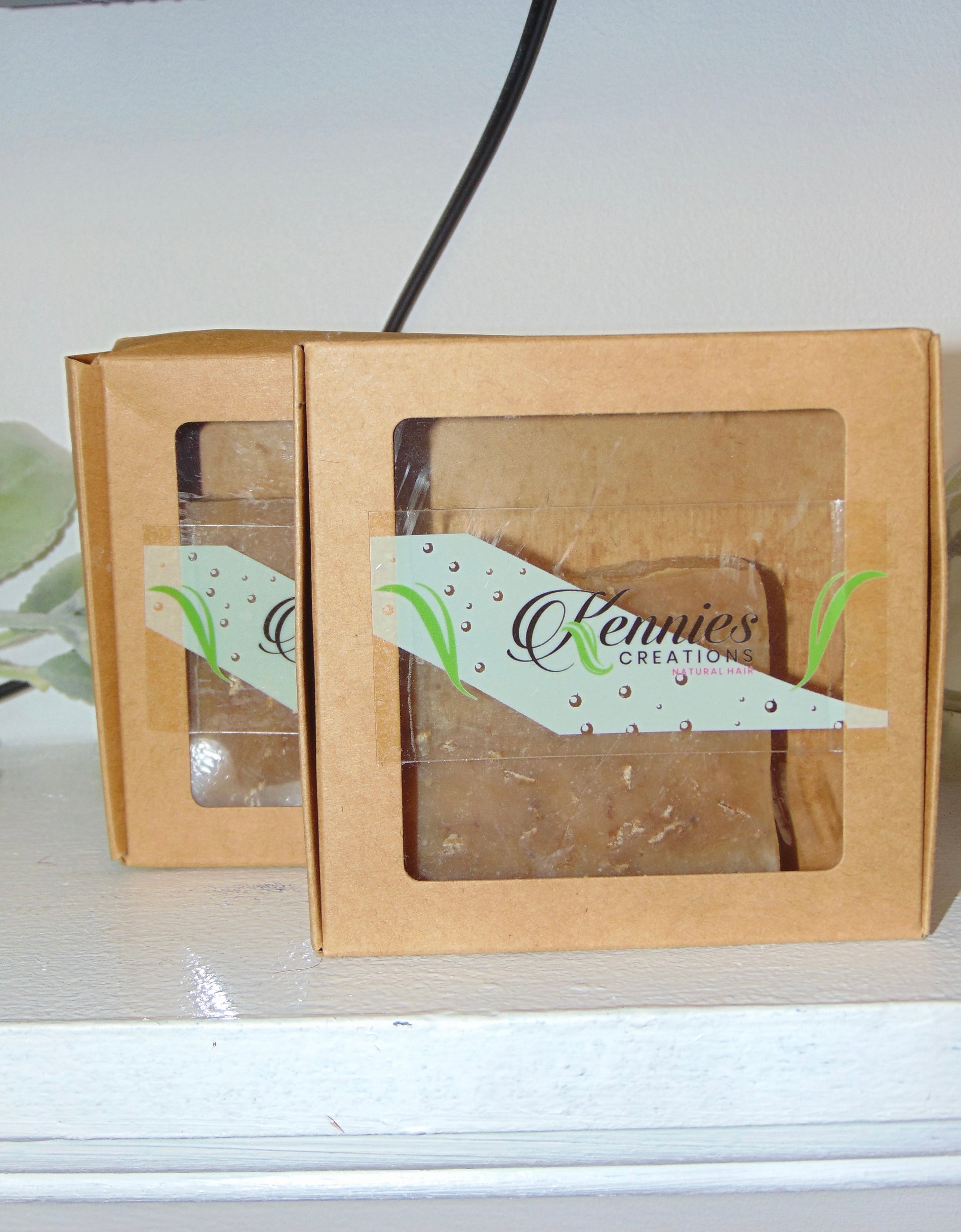One brown cardboard boxes with clear window panels on a tan background.